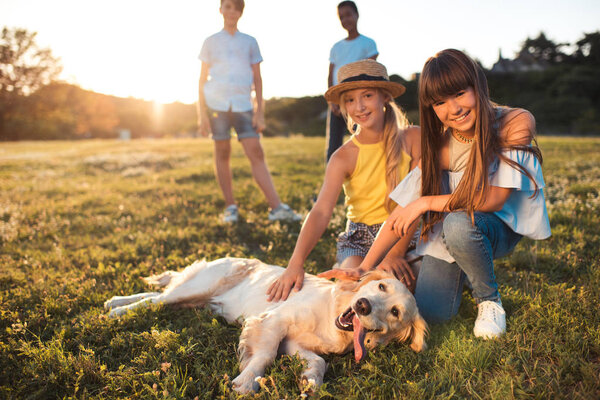 teenagers with dog in park