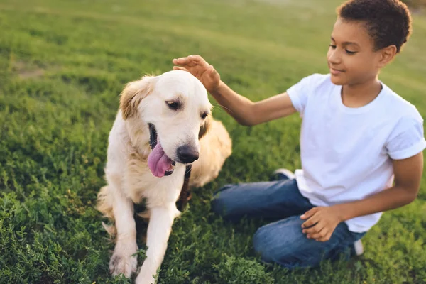 African american teenager with dog — Stock Photo, Image