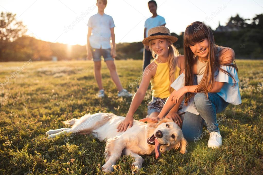 teenagers with dog in park