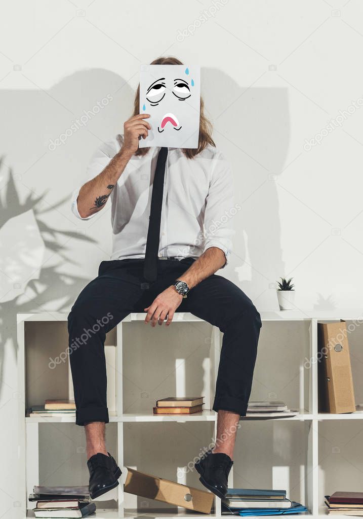 businessman holding card with funny face