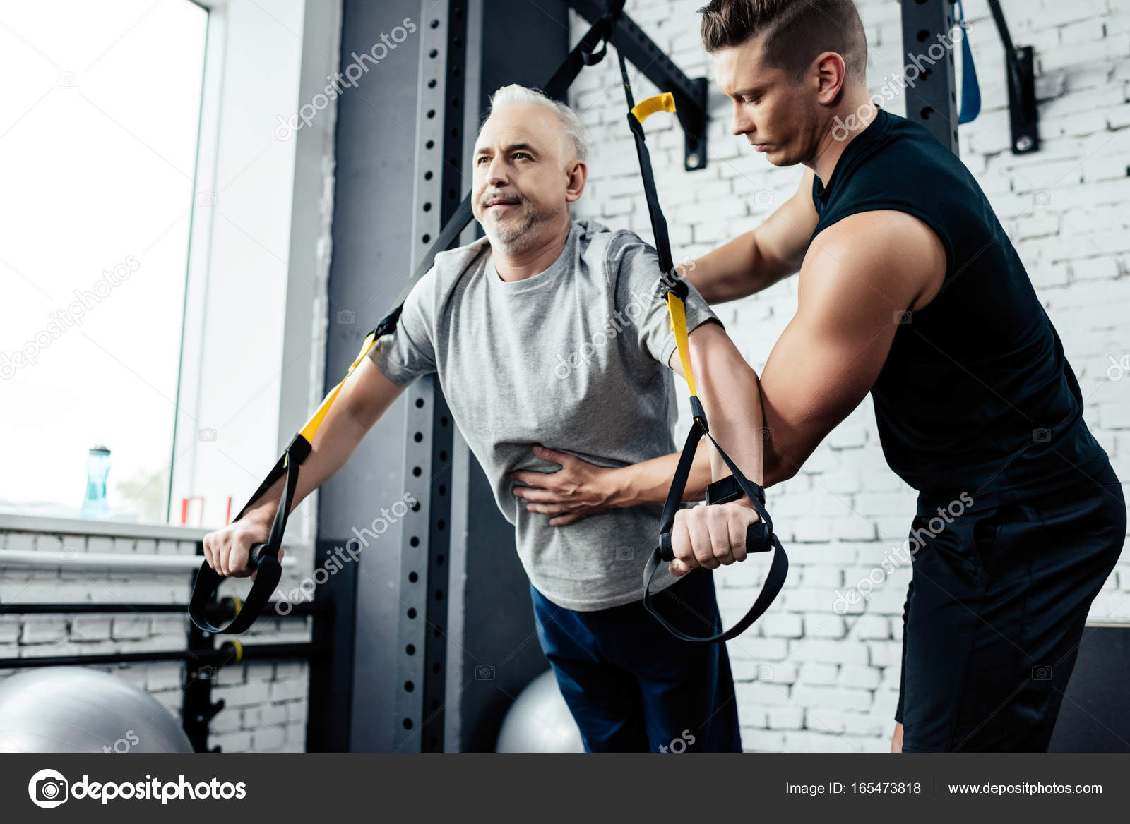 Senior sportsman training with trx — Stock Photo © ArturVerkhovetskiy 165473818