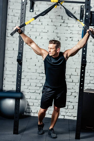 Sportsman with trx resistance bands — Stock Photo, Image