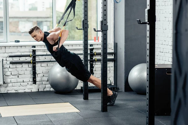 Sportsman training with trx — Stock Photo, Image