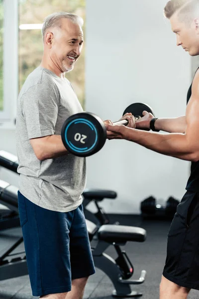 Senior sportsman with barbell — Stock Photo, Image