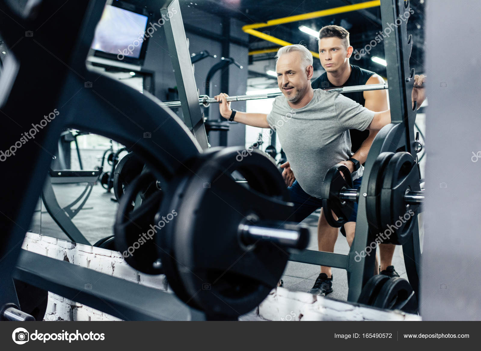 Senior sportsman lifting barbell — Stock Photo © ArturVerkhovetskiy