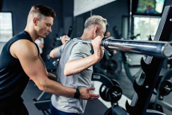 Senior sportman hijs barbell — Stockfoto