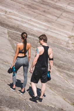 sportive couple walking on slabs clipart