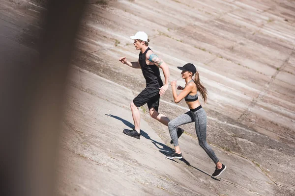 Couple jogging on slabs — Stock Photo, Image