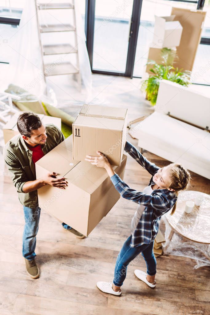 couple with cardboard boxes in new house