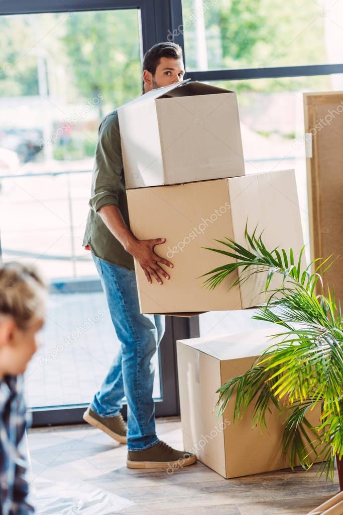 man holding cardboard boxes