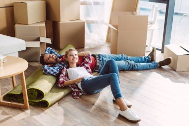 couple resting in new house clipart