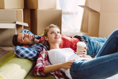 couple resting in new house clipart