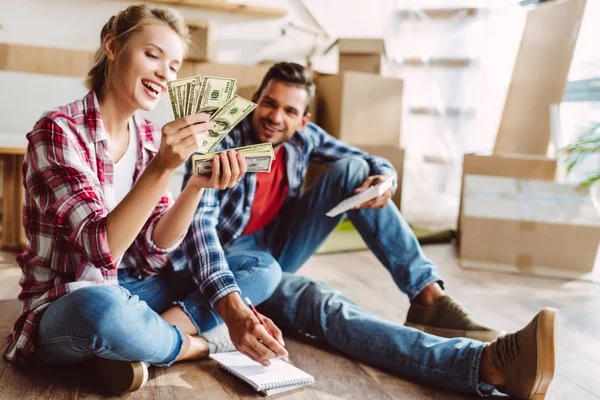 Pareja joven contando dinero — Foto de Stock