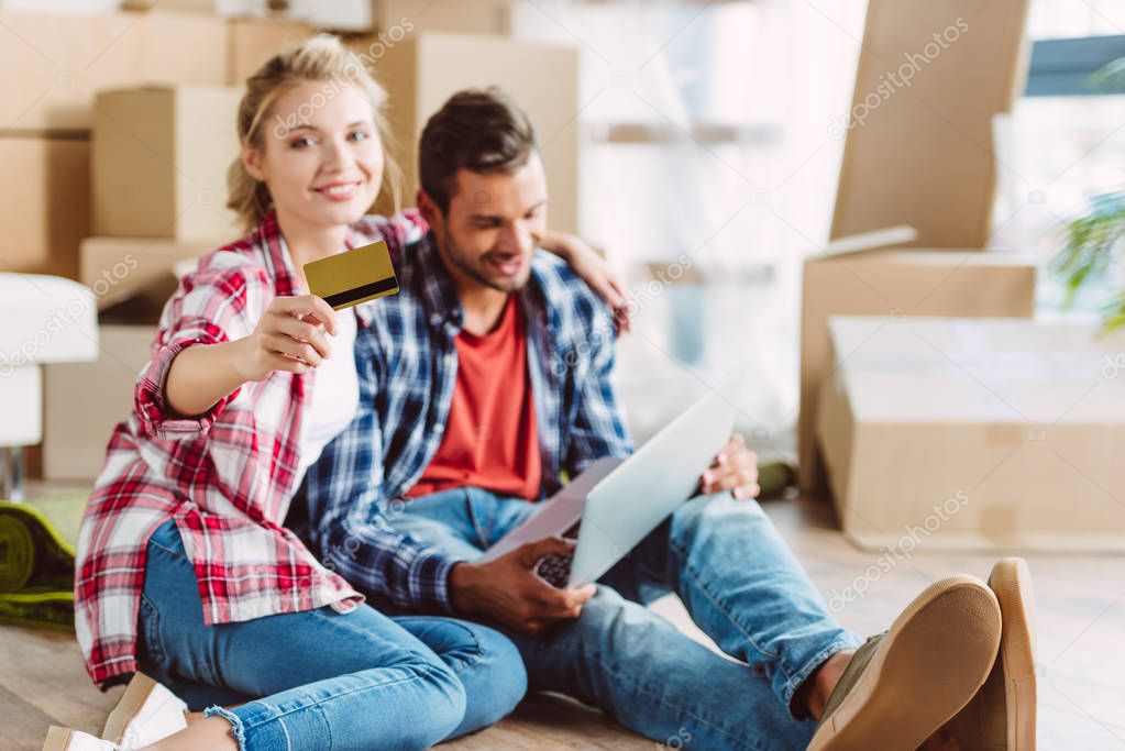 couple with laptop and credit card