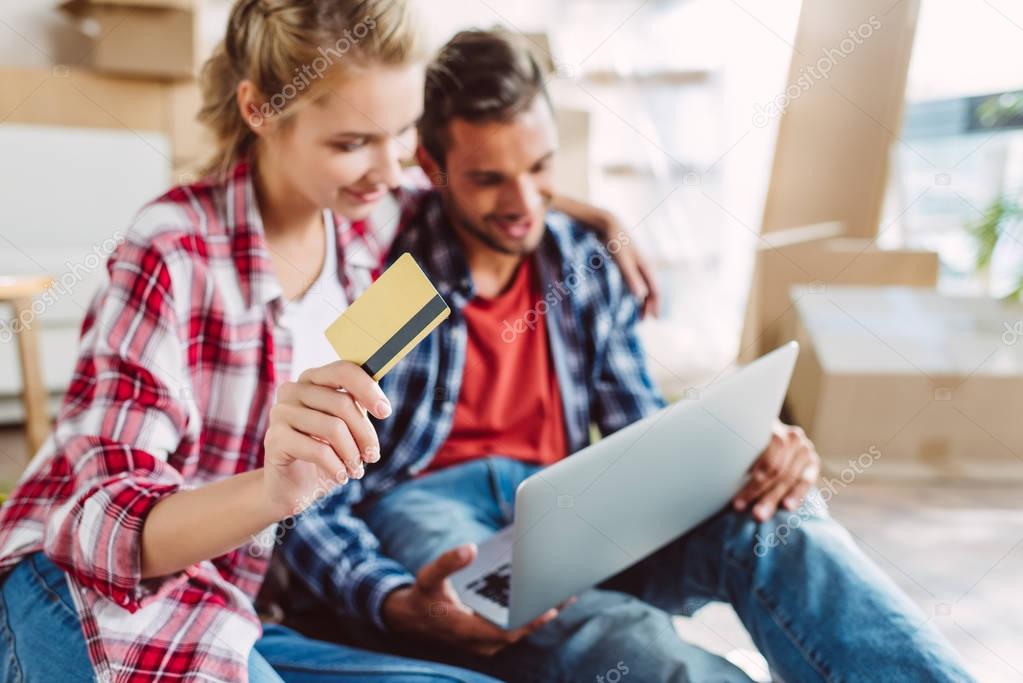 couple with laptop and credit card