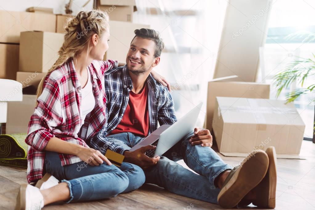 couple with laptop and credit card