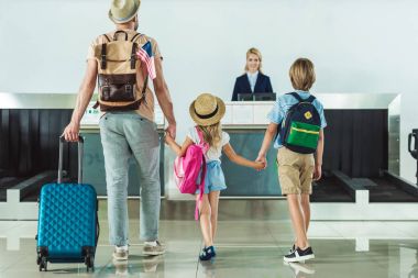 family going to check in desk