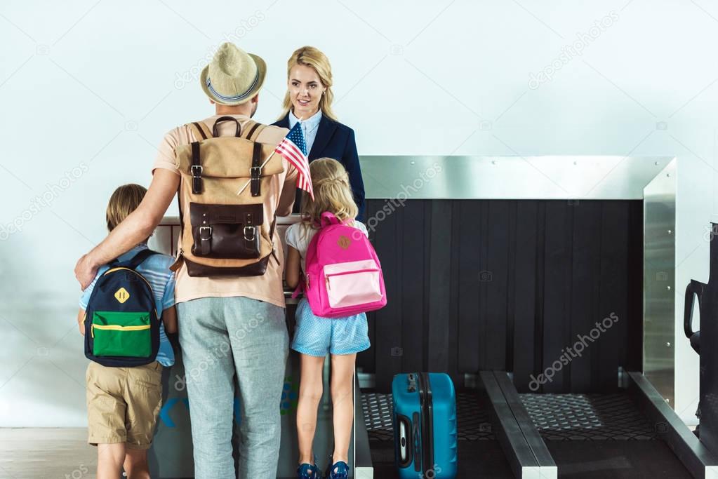 family at check in desk at airport