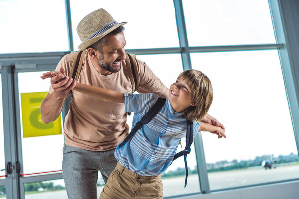 father and kid in airport