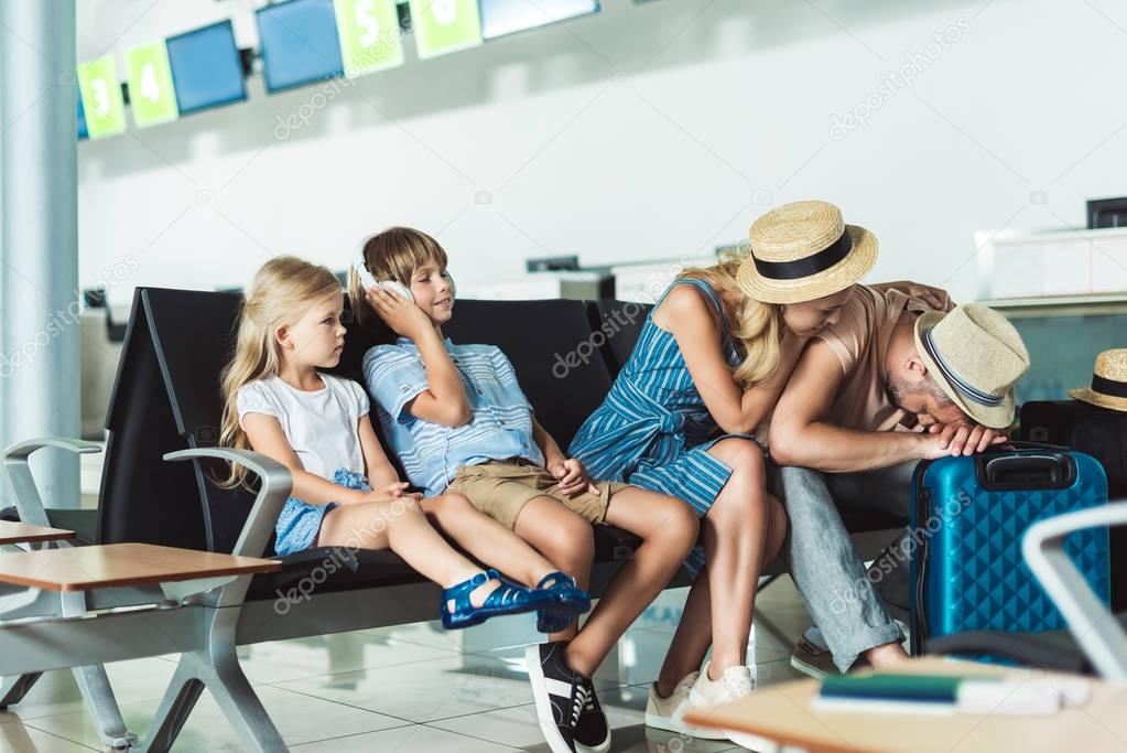 family waiting for boarding at airport