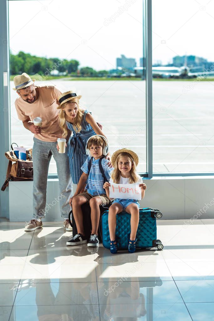 parents and kids waiting for boarding in airport