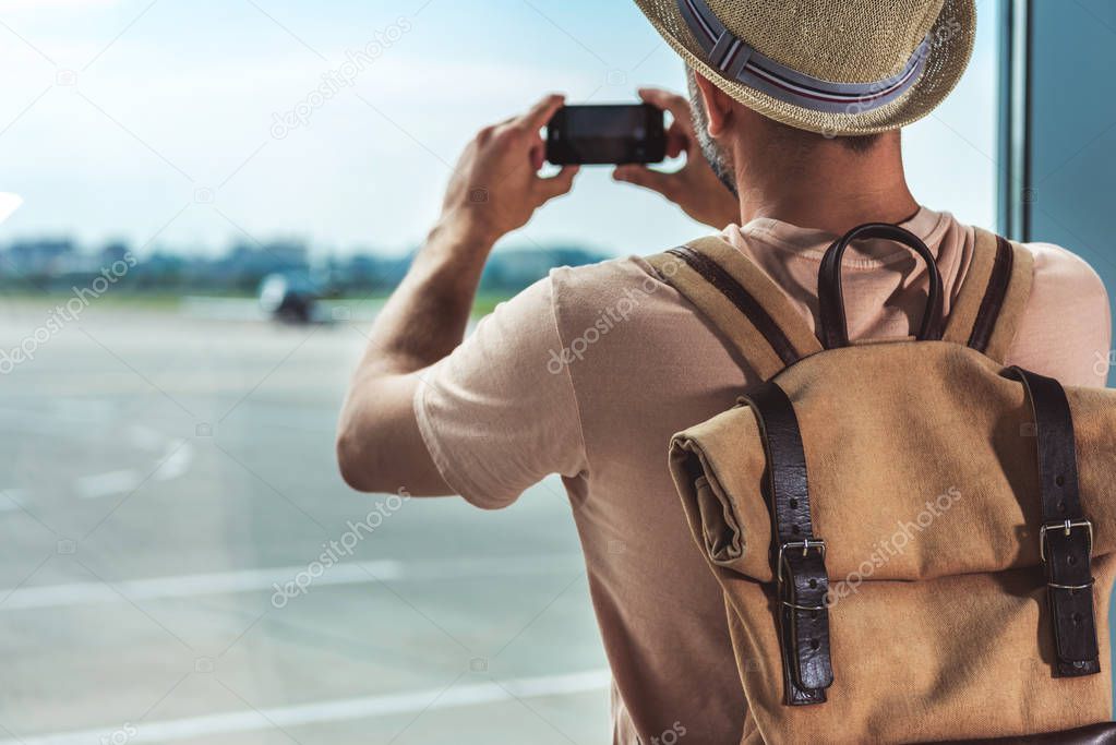 man taking picture on smartphone