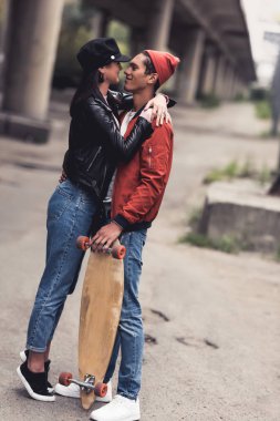 couple with skateboard embracing clipart