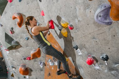 woman climbing wall with grips clipart