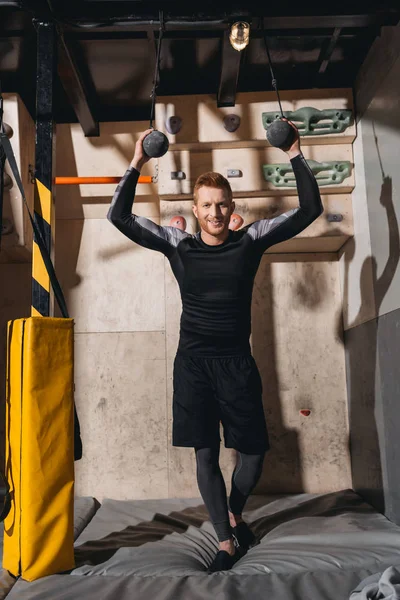 Young man with kettlebells — Free Stock Photo