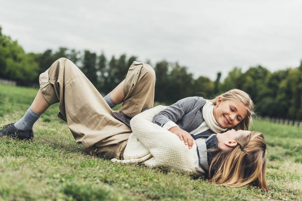 family lying on grass at countryside 