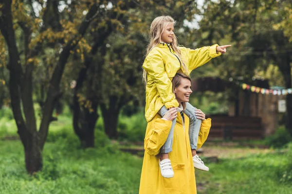 Moeder en dochter in regenjassen — Stockfoto