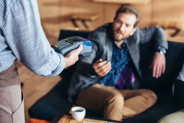 Person using payment terminal