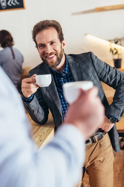 Businessmen drinking coffee in cafe — Stock Photo, Image