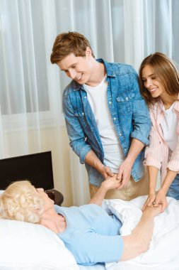 Couple visiting sick senior woman clipart