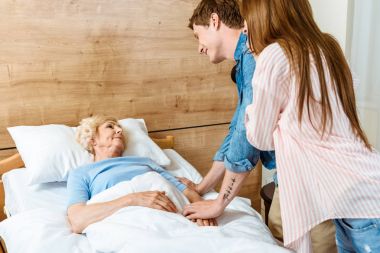 Man visiting sick elderly woman clipart