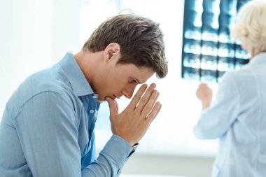 Young man dissapointed by diagnosis clipart
