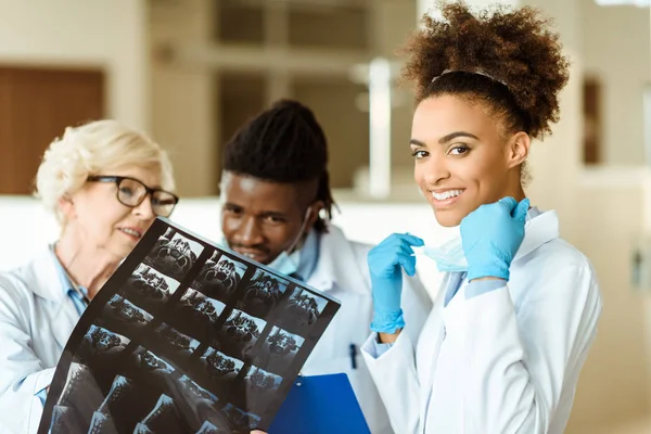 Young african american doctor with colleagues — Stock Photo, Image