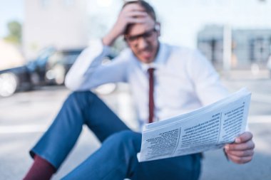 stressed businessman with newspaper clipart