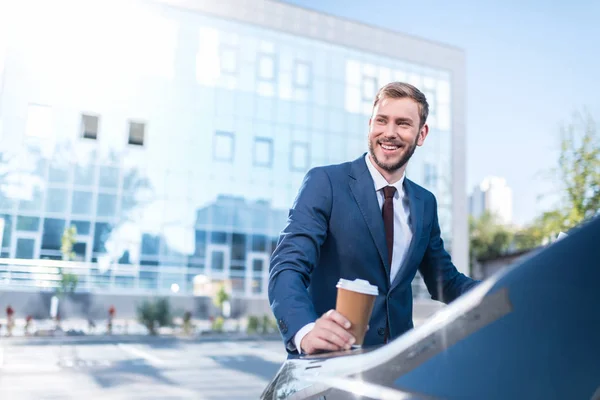 Businessman with disposable cup of coffee — Stock Photo, Image