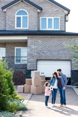 family in front of new house clipart