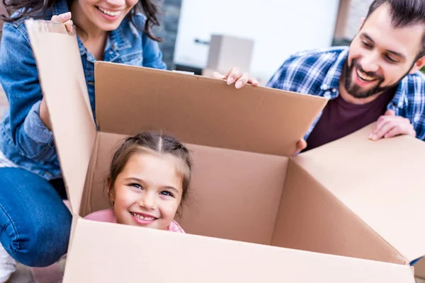 Girl sitting in cardboard box — Stock Photo, Image