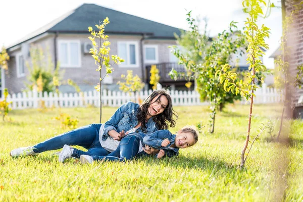 Mother cuddling her little daughter — Stock Photo, Image