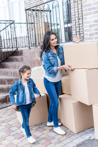 mother and daughter with cardboard boxes