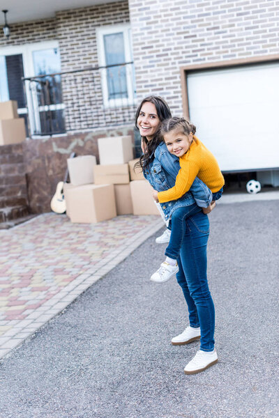 daughter piggyback riding mother