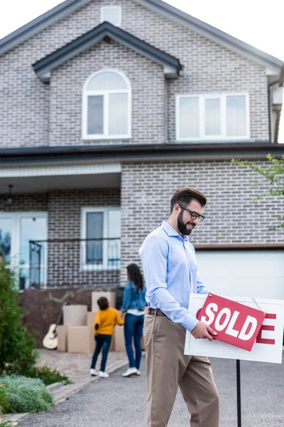 Realtor with sale signboard — Stock Photo, Image