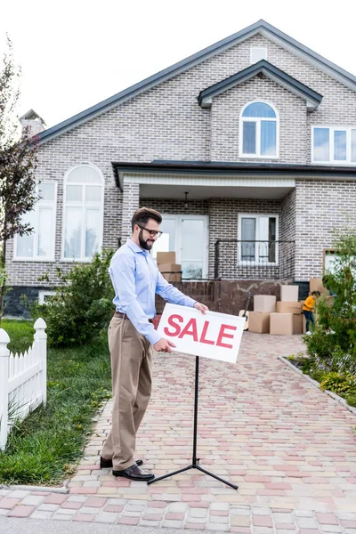 Realtor with sale signboard — Stock Photo, Image