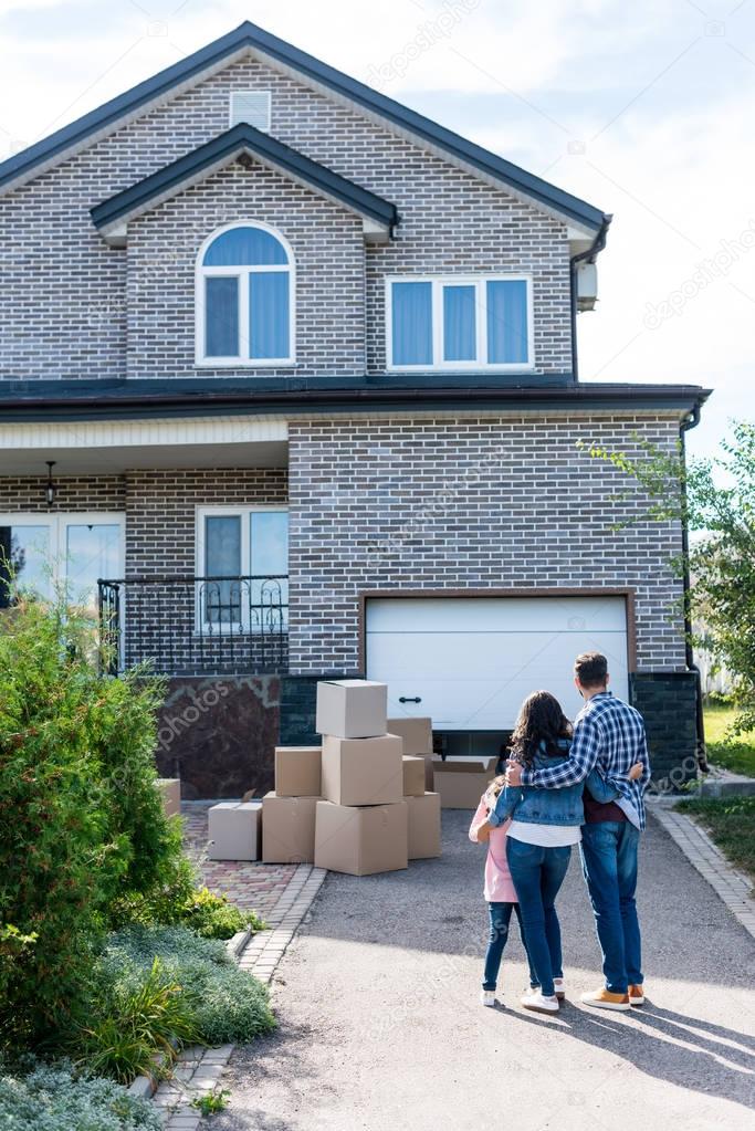 Young family looking at new house after moving