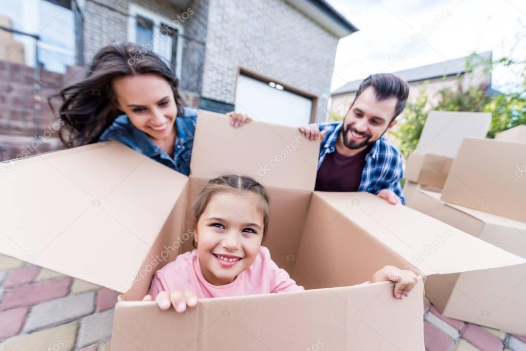 girl sitting in cardboard box