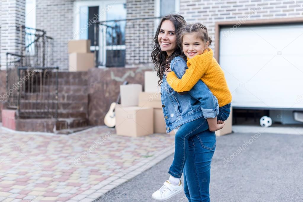 daughter piggyback riding mother