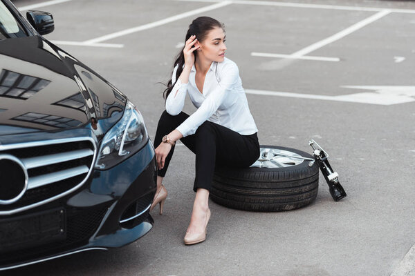 woman sitting on tire
